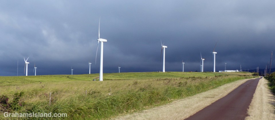 Dark clouds roll across the Kohala Mountains providing a dramatic backdrop to the turbines of Hawi Wind Farm.