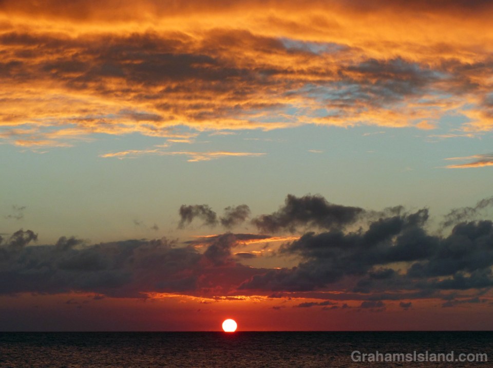 The sun slips into the sea off the Big Island.