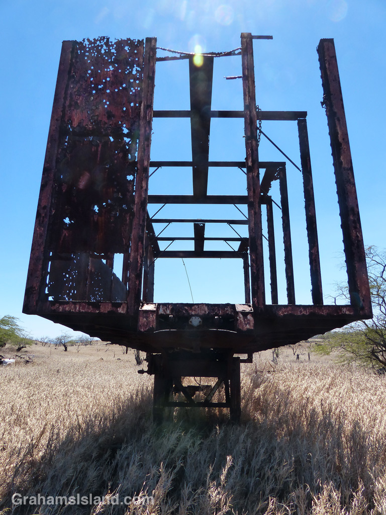 An old trailer rusts away in a field near the Kohala coast.