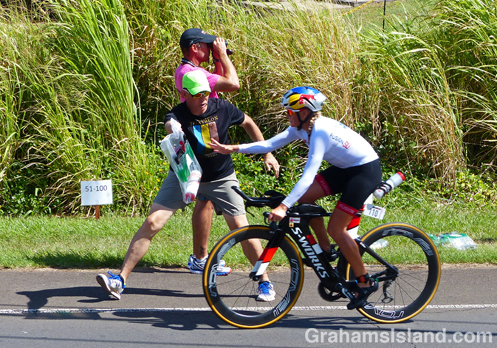 Camilla Pedersen of Denmark receiving her bag from one of the Ironman volunteers