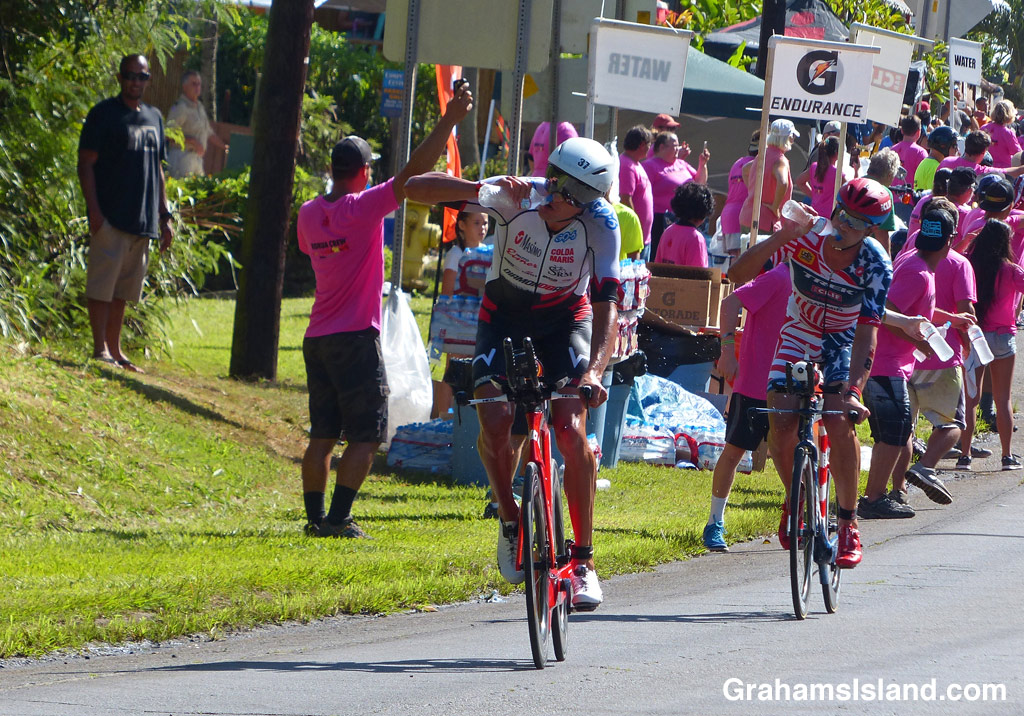 Michael Weiss of Austria and Tim O'Donnell of the U.S.A. take on water at the IRONMAN world championship
