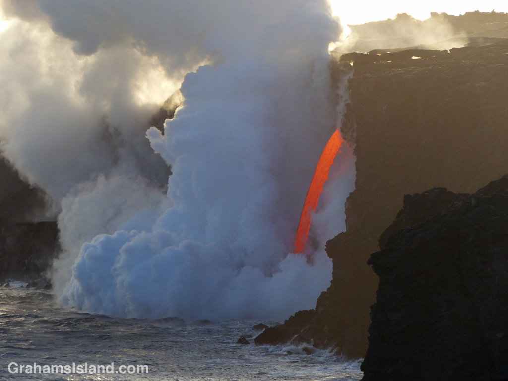 Lava from Kilauea Volcano’s Pu’u O’o vent enters the ocean as if from a firehose.