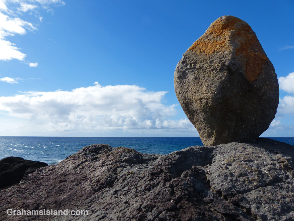 A rock sits balanced on the coast of the Big Island of Hawaii