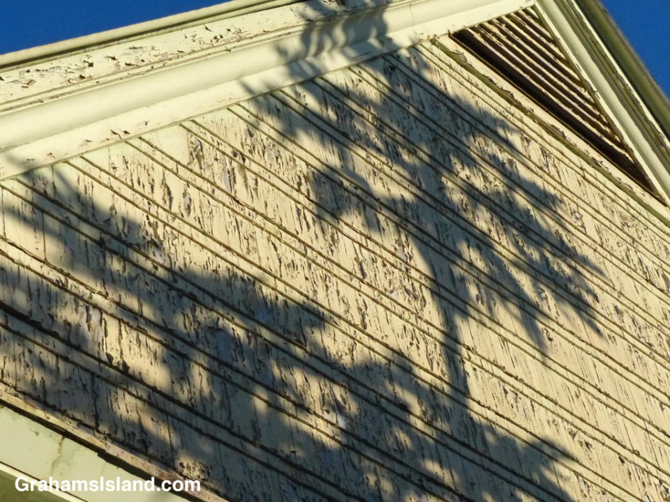 Shadows play on a peeling surface of the old Bond Library in Kapaau.