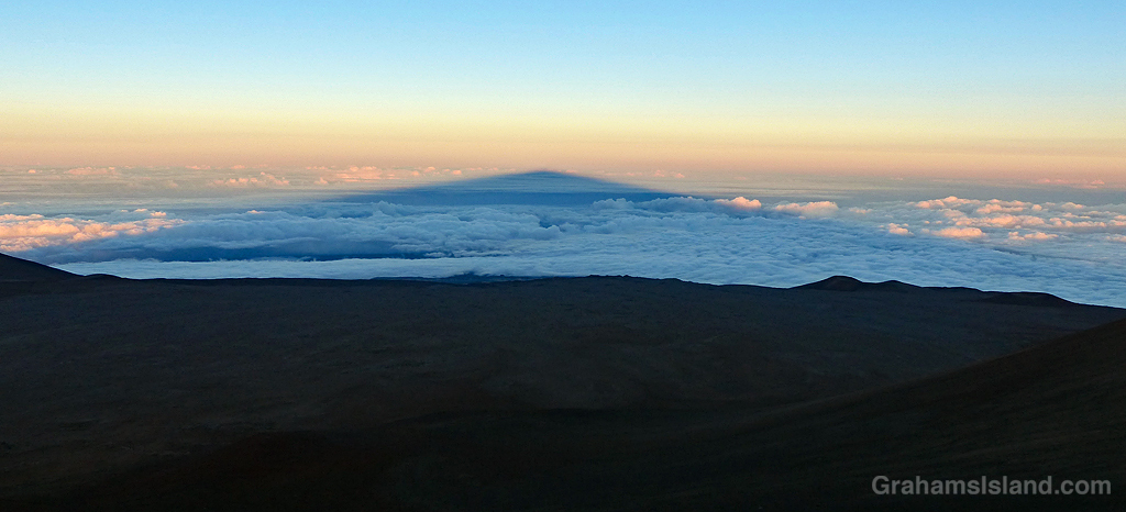 The shadow of Mauna Kea stretches out above the clouds.