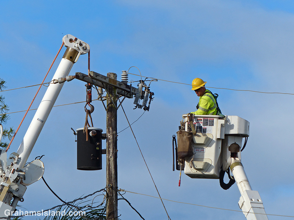 Workers prepare to remove and electrical transformer
