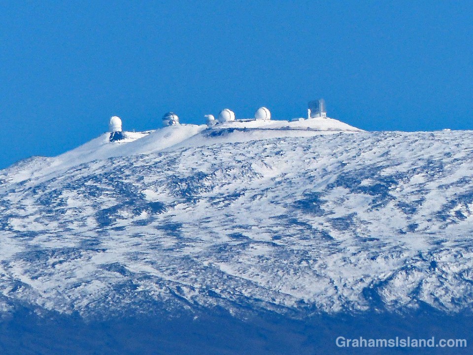 Snow covers the top of Mauna Kea and its telescopes.