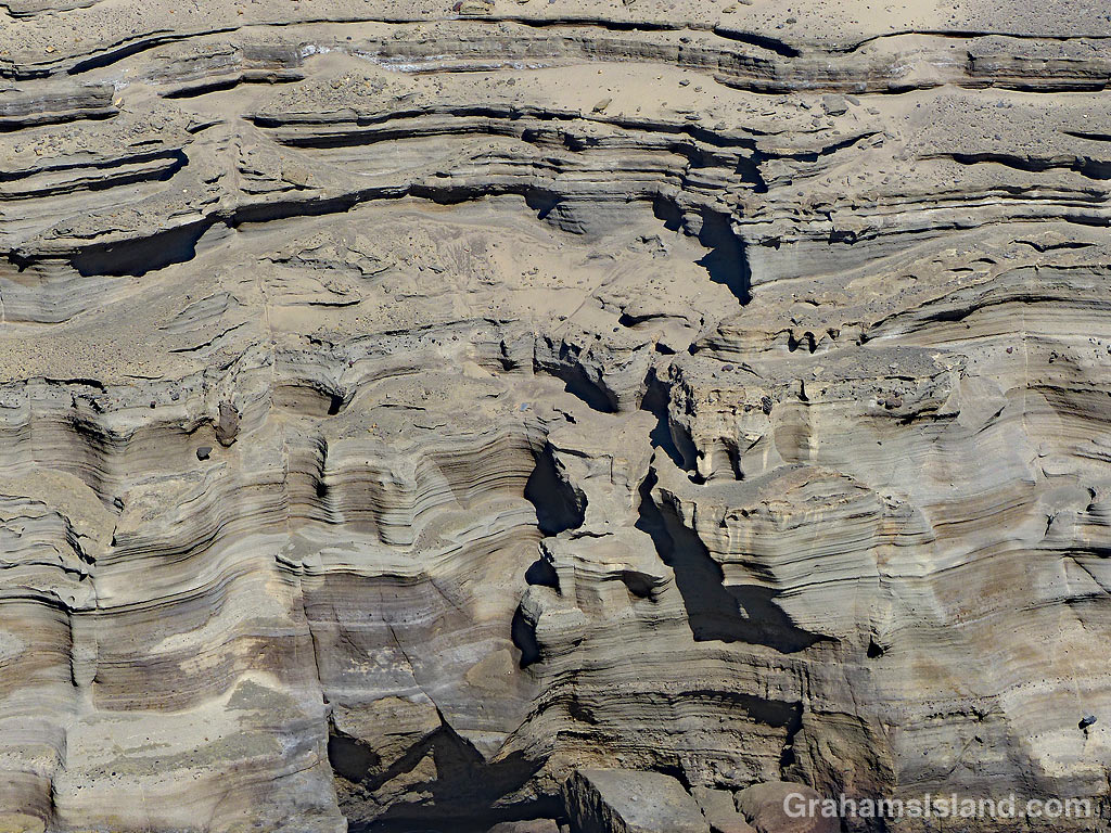 Abstracts-Cliff above green sand beach