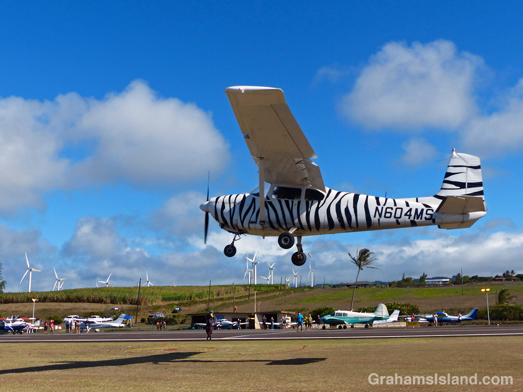 A small plane flies low over Upolu Airport, Hawaii.