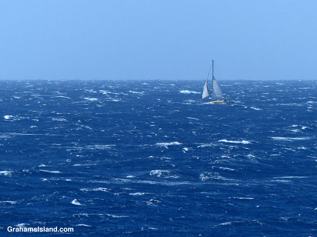 A sailboat in white water off the Big Island, Hawaii