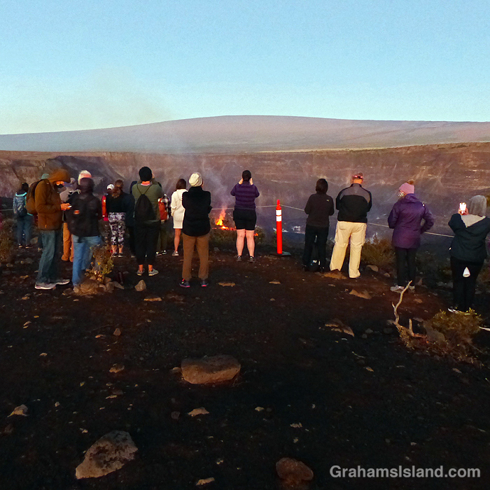People view the lava cone and lake at Kilauea Volcano in late 2021