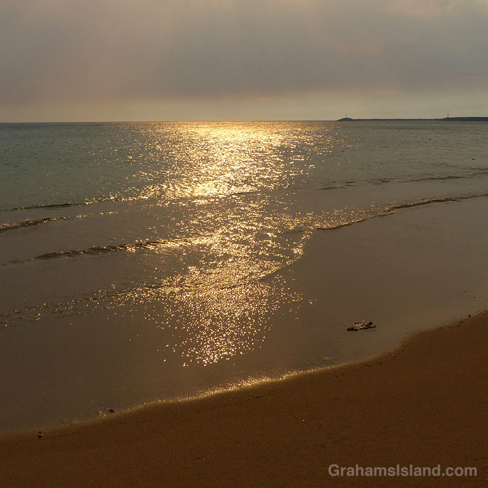 Smoky skies cause golden light on the waters of Hawaii