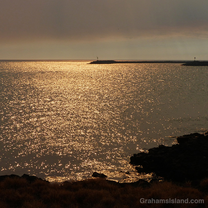 Smoky skies cause golden light on the waters of Hawaii