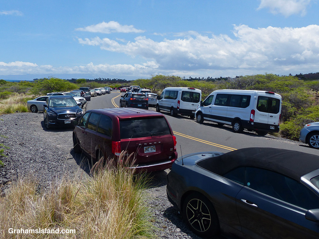 Cars parked on the road to Kua Bay Beach Park in Hawaii