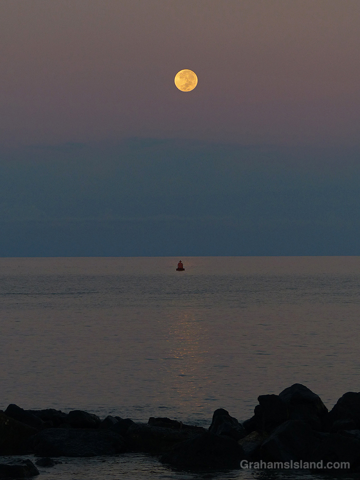 A full moon setting over North Kohala, Hawaii