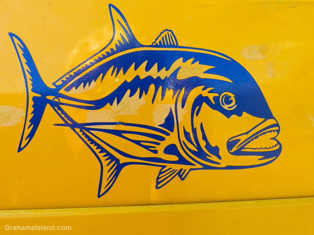 A blue fish decal on a yellow car