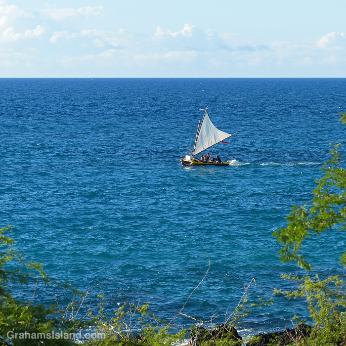 A small sailboat off the coast of Hawaii