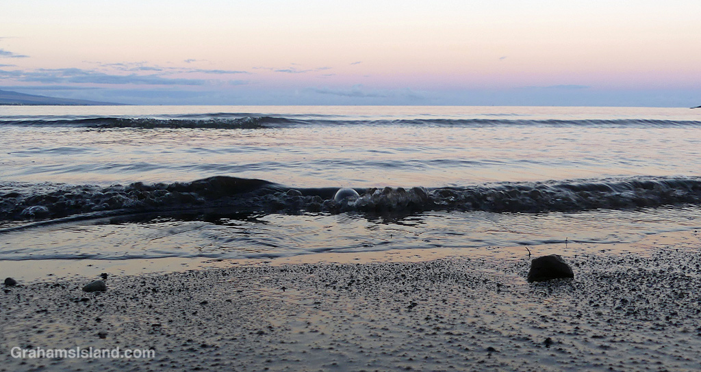 Small waves wash ashore at Pelekane Beach Hawaii