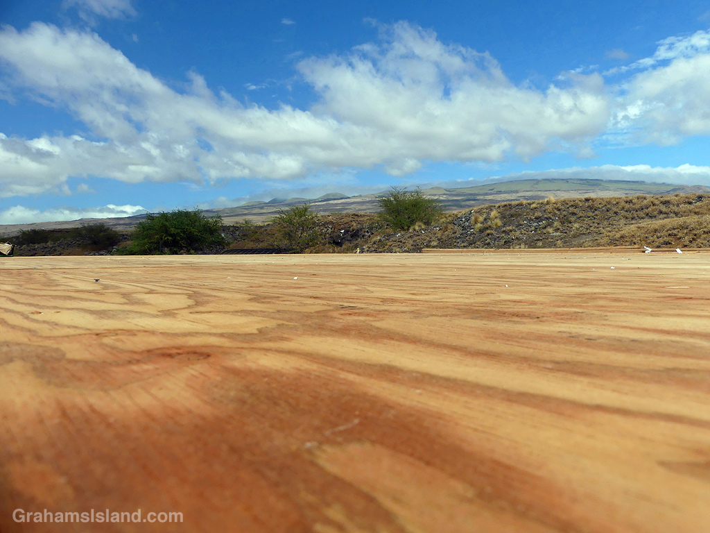 A plywood floor with Kohala Mountain in the background