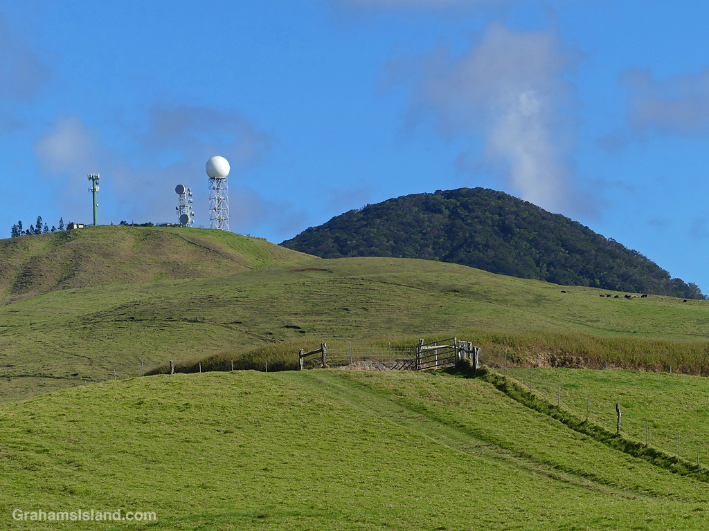 The rounded hills of Kohala Mountain and a weather radar known as the golfball
