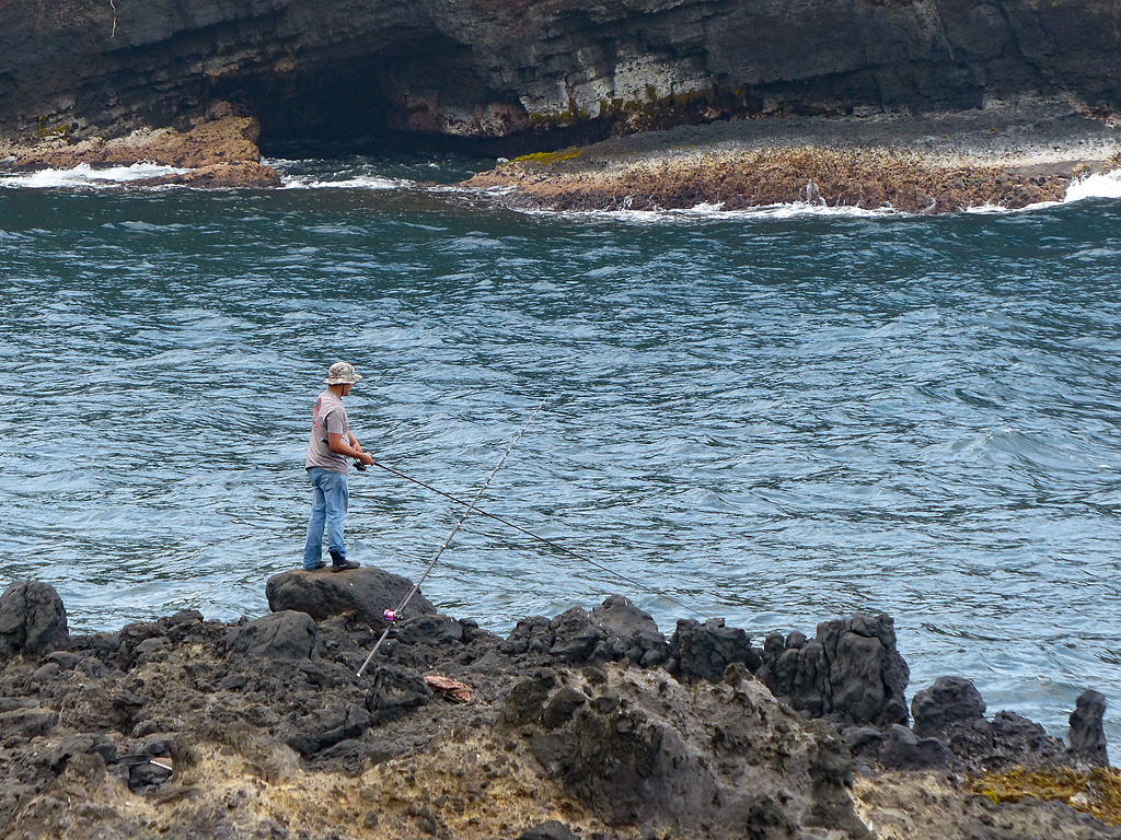 A fisherman tries his luck in the waters off Hawaii