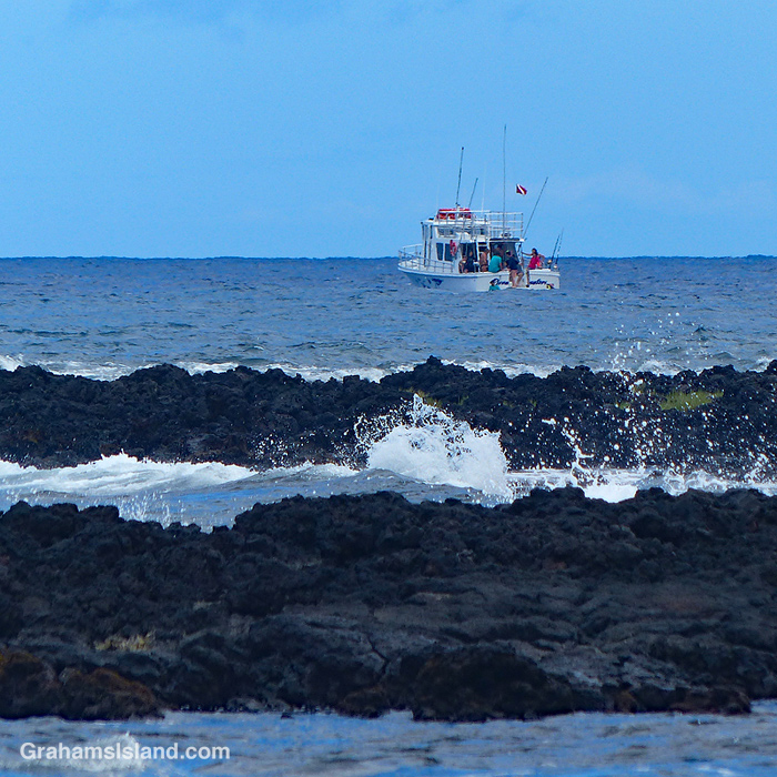 A dive boat anchored off the Kona Coast in Hawaii