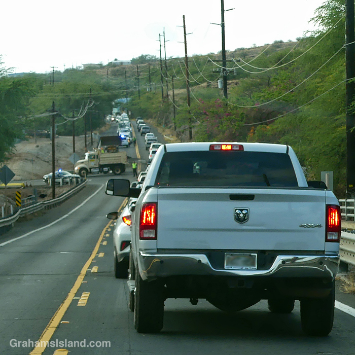 Cars wait on the road into Kawaihae Hawaii as a traffic accident is cleared