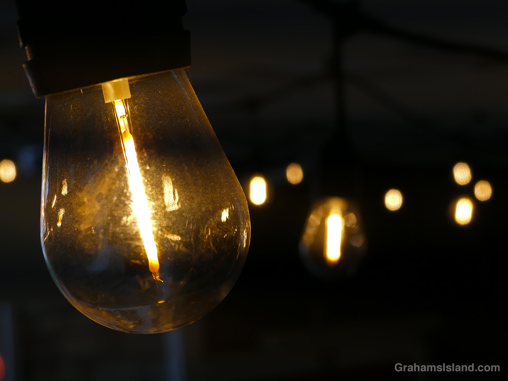 Light bulbs shining in a dark space