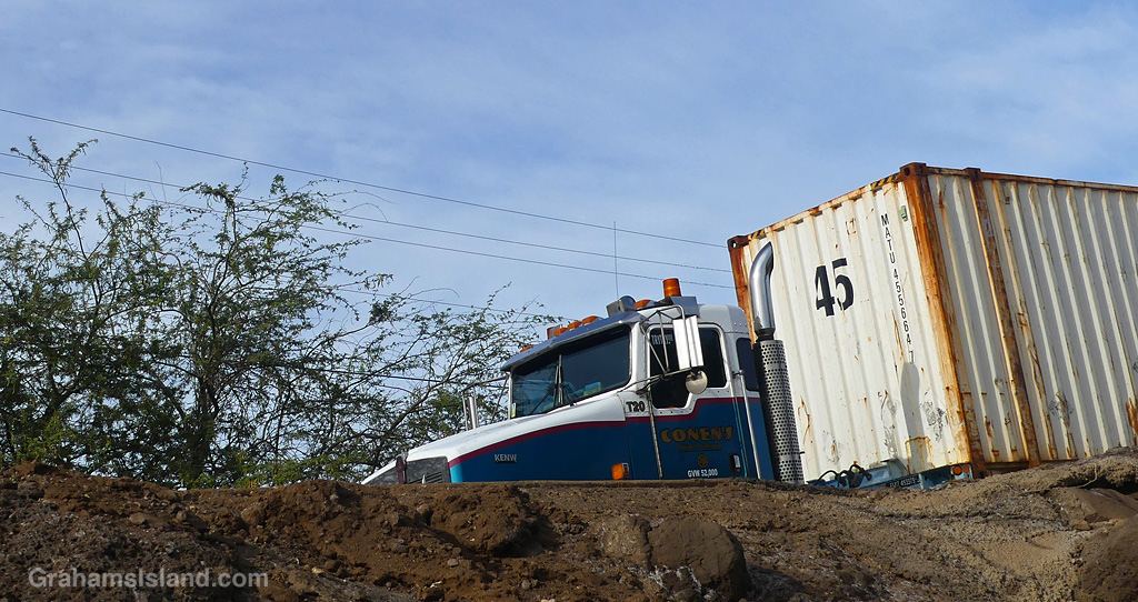 A semi truck passes on a raised highway in Hawaii