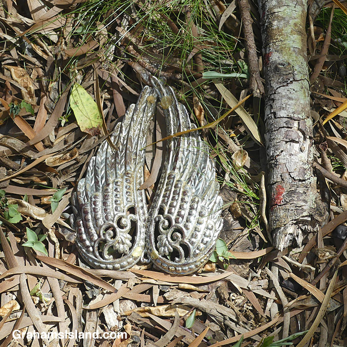 A pair of metal wings on the ground in Hawaii