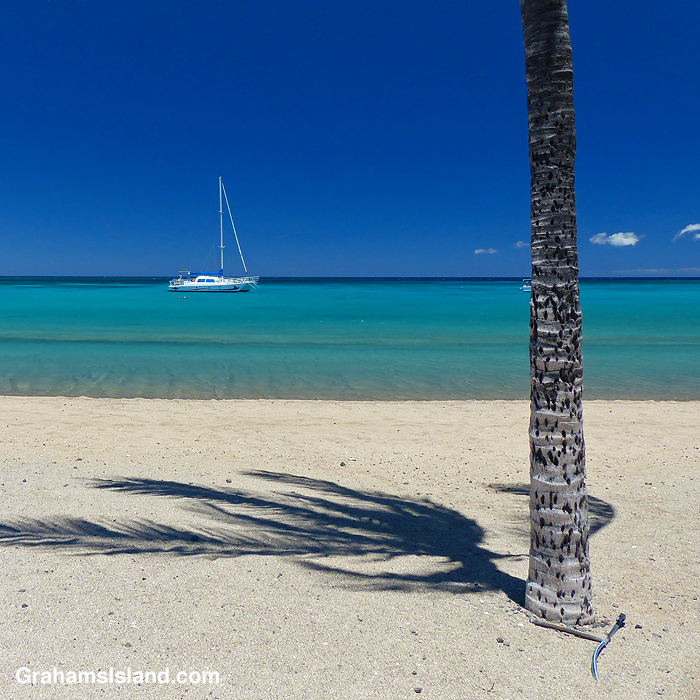 A boat anchored off the beach at Anaehoomalu Bay in Hawaii