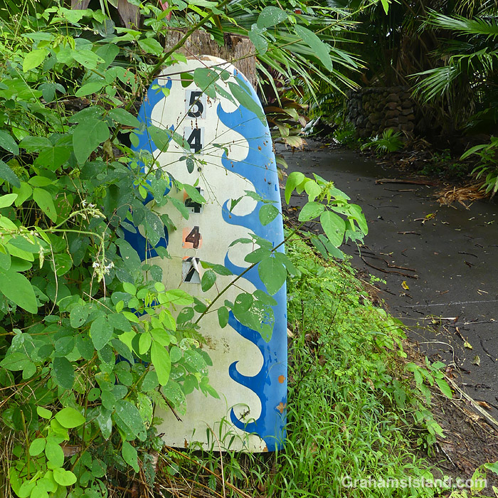 A surfboard being used to display address numbers in Hawaii