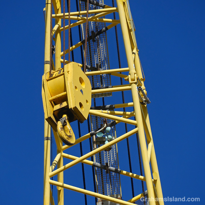 A hook and anemometer on the boom of a crane in Hawaii