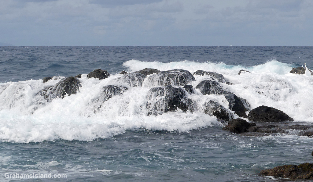 Waves beak over the rocks in Hawaii
