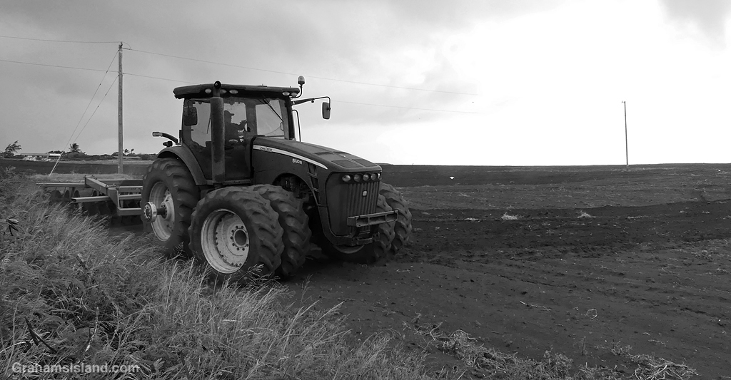 A tractor pulling a harrow in Hawaii