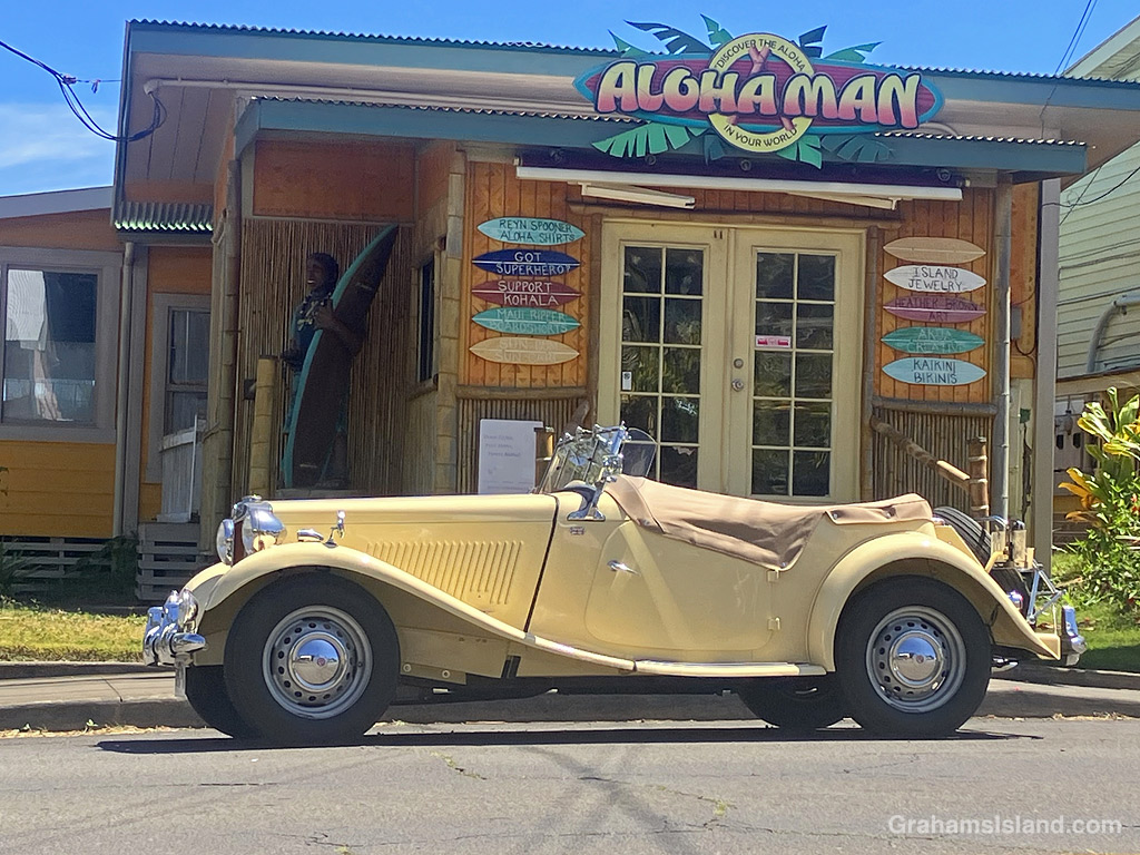 An MG car parked in front of a store in Hawi, Hawaii