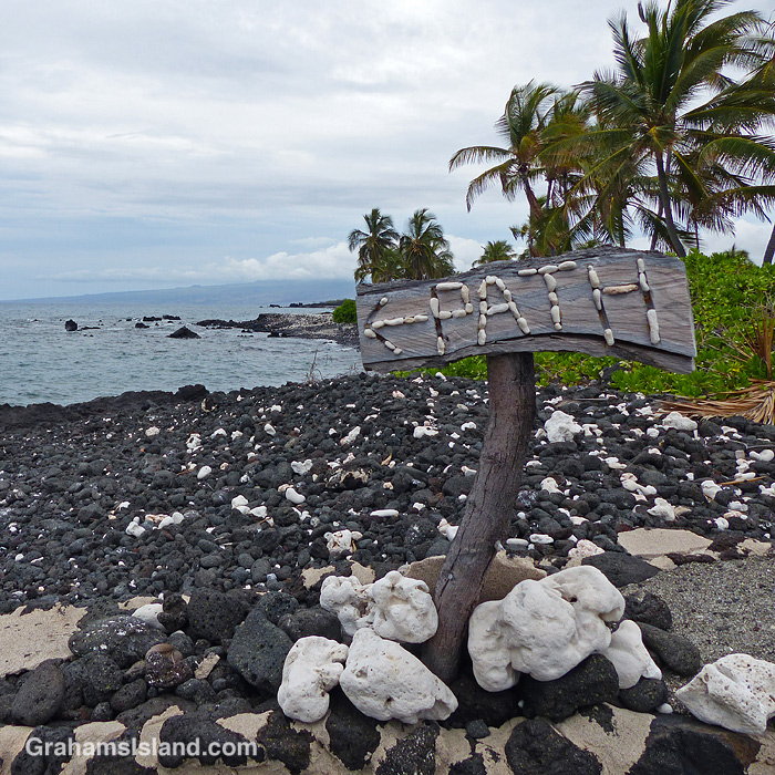 A sign marks the trail at Weliweli Point on the Big Island of Hawaii