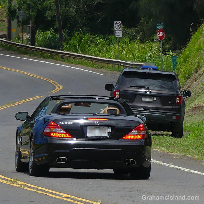 A car brakes at the sight of a police car in Hawi Hawaii