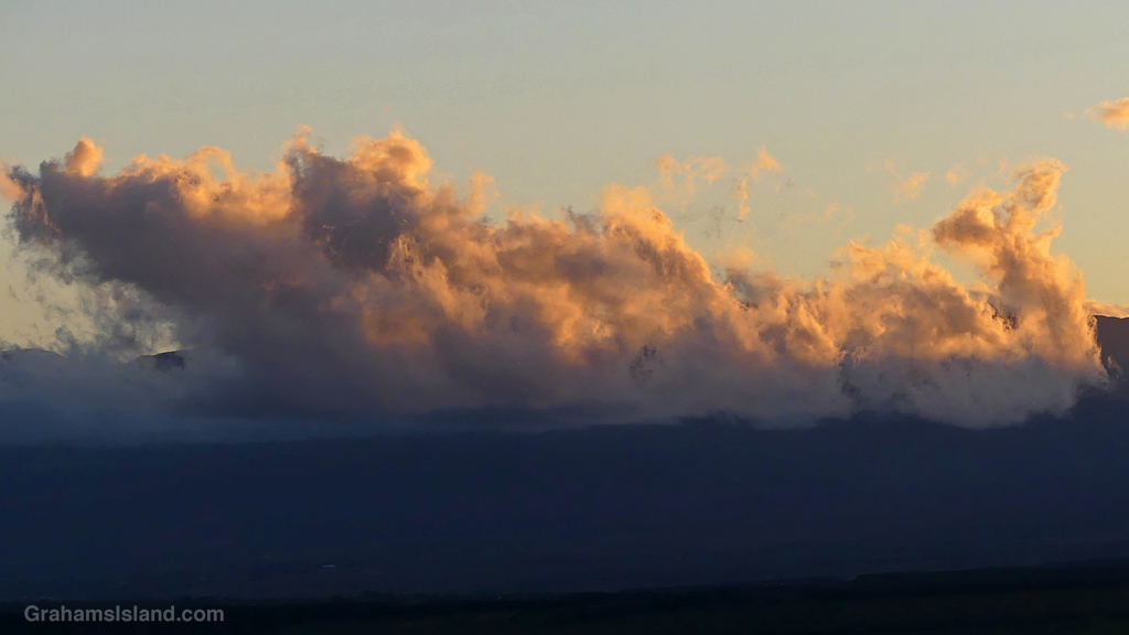 The morning sun illuminates clouds over Kohala in Hawaii