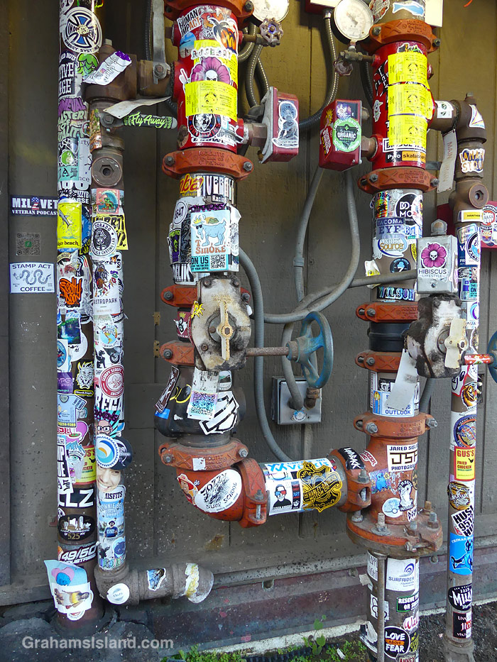 Stickers on utility pipes at Kailua Kona airport in Hawaii