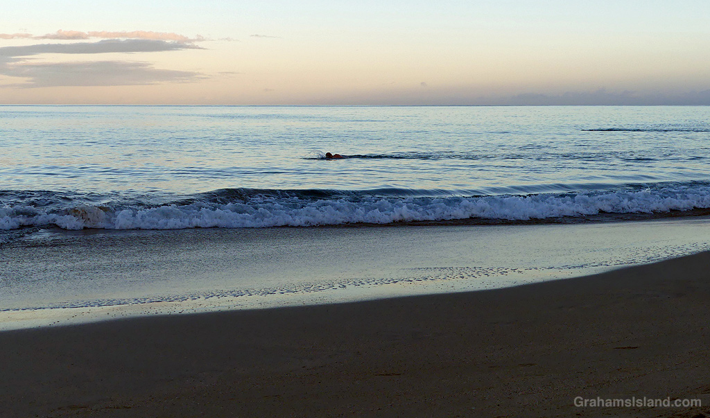 An early morning swimmer at Hapuna Beach, Hawaii