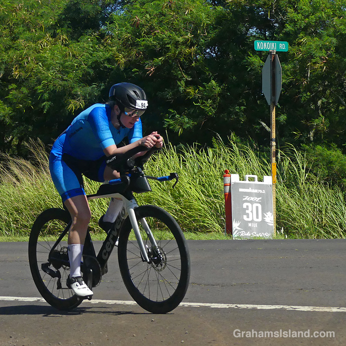 A cyclist in the 2026 Ironman 70.3 race in Hawaii, passes the 30 mile marker
