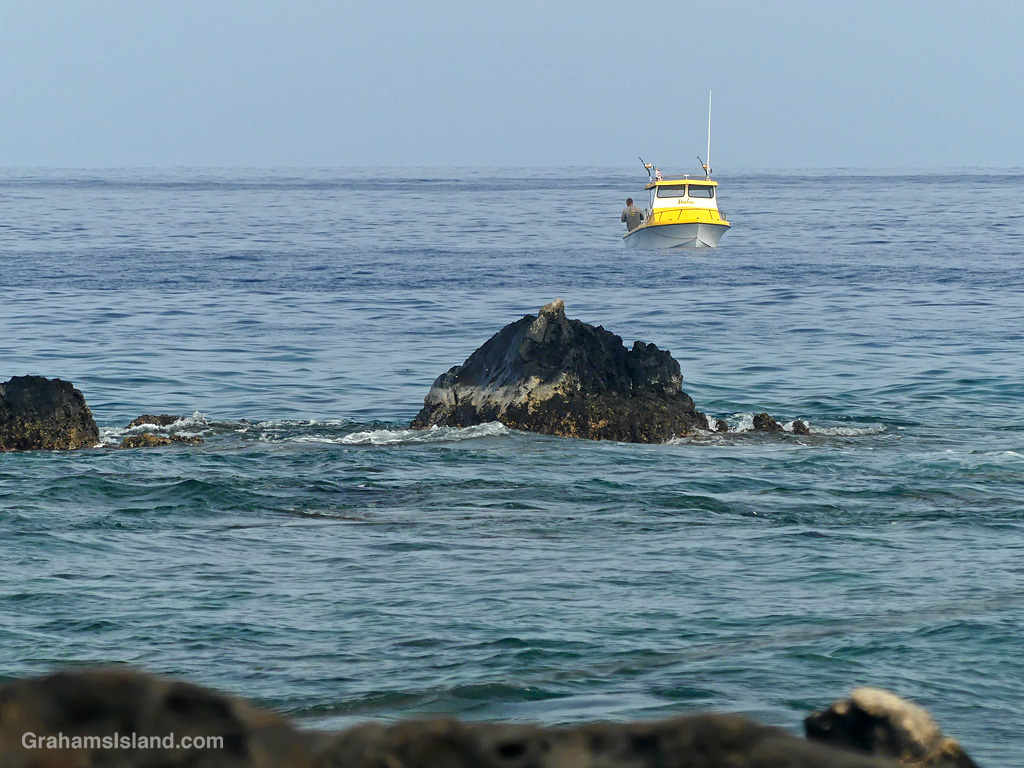 A yellow fishing boat off the coast of Hawaii
