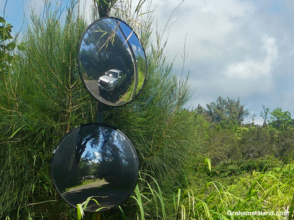 Reflections in a pair of mirrors beside a road in Hawaii