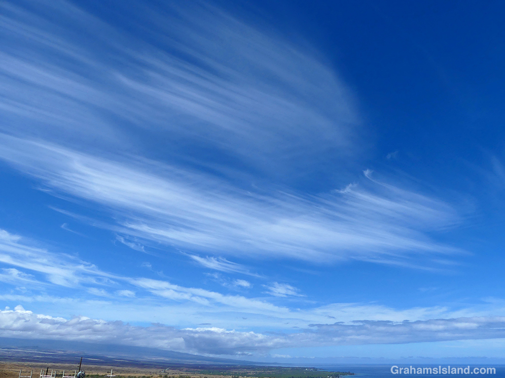 Clouds scud across a blue sky in Hawaii