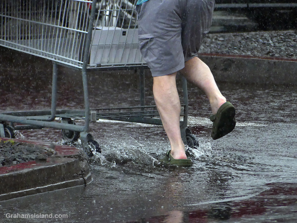 Feet splashing through rain puddles in Kailua Kona, Hawaii