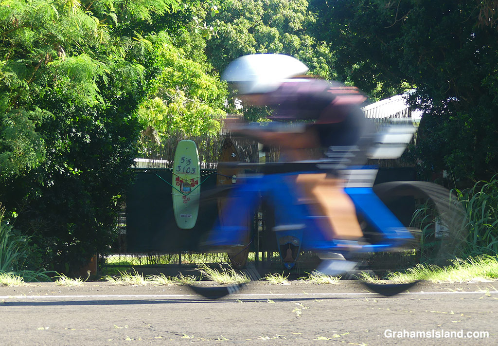 A cyclist speeds by in Hawaii