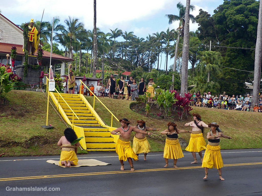 Hula dancers perform in front of steps leading to the statue of King Kamehameha in Kapaau, Hawaii