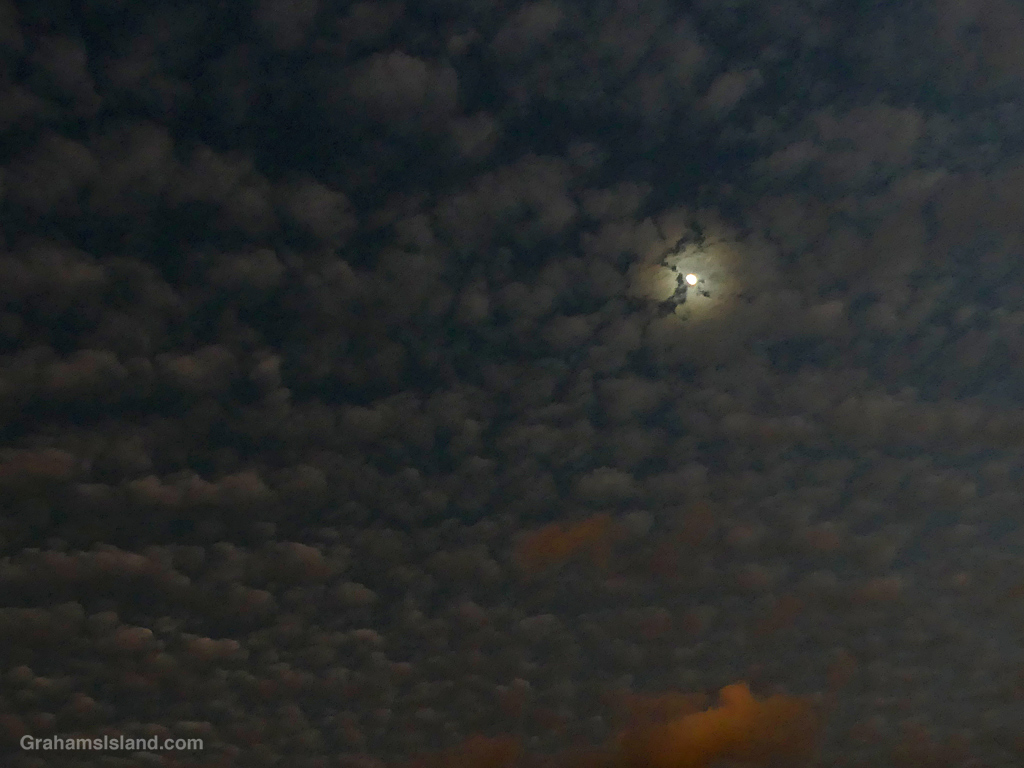 Moon and puffy clouds over Hawi, Hawaii