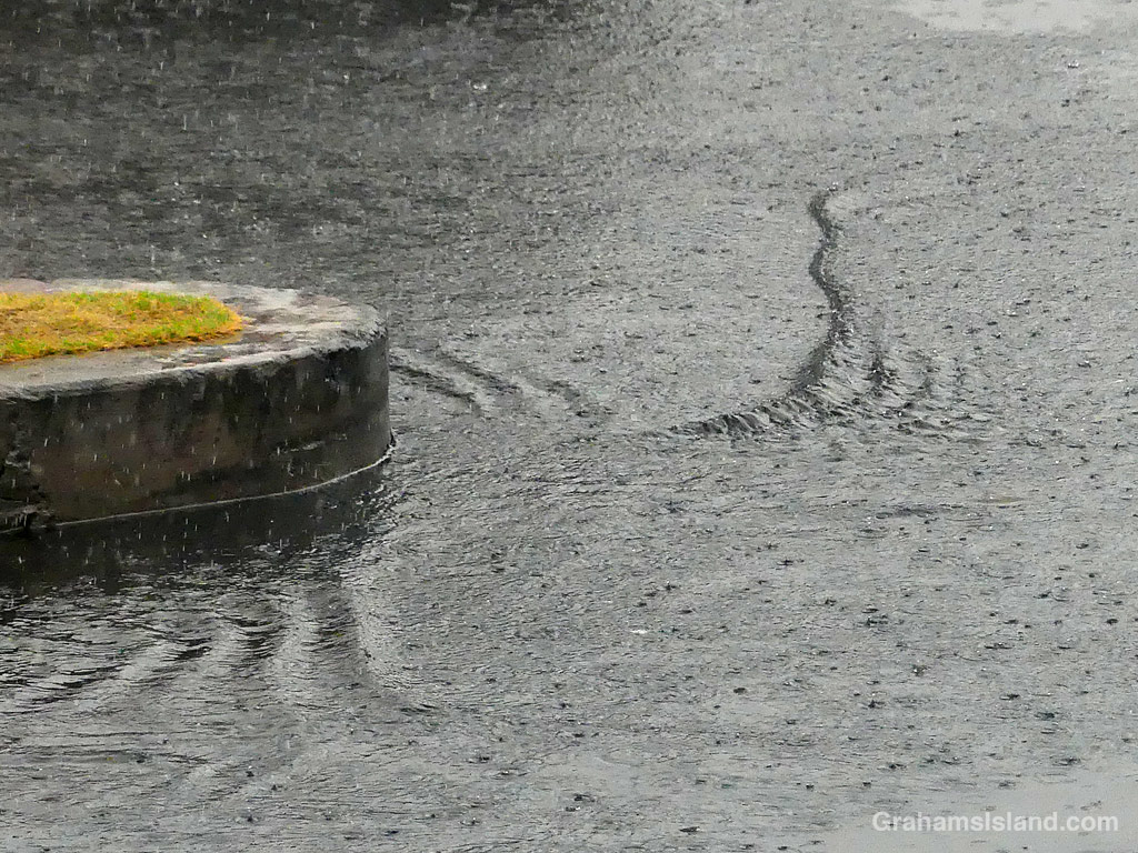 Rain rippling through a parking lot in Kailua Kona, Hawaii